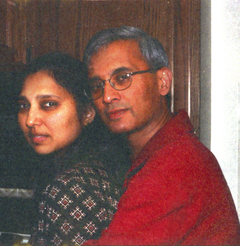 A husband and wife seated close together, back to back, in an intimate portrait from 2000