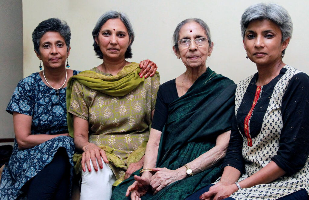 Four women sitting together in a portrait, an elderly mother with her three daughters, 2013