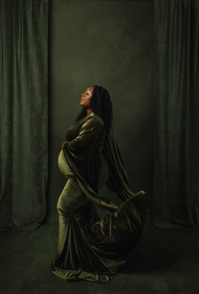 Original maternity photograph of a pregnant woman in a green velvet gown, before hand-painting, by Anj Portrait Studio in Des Moines